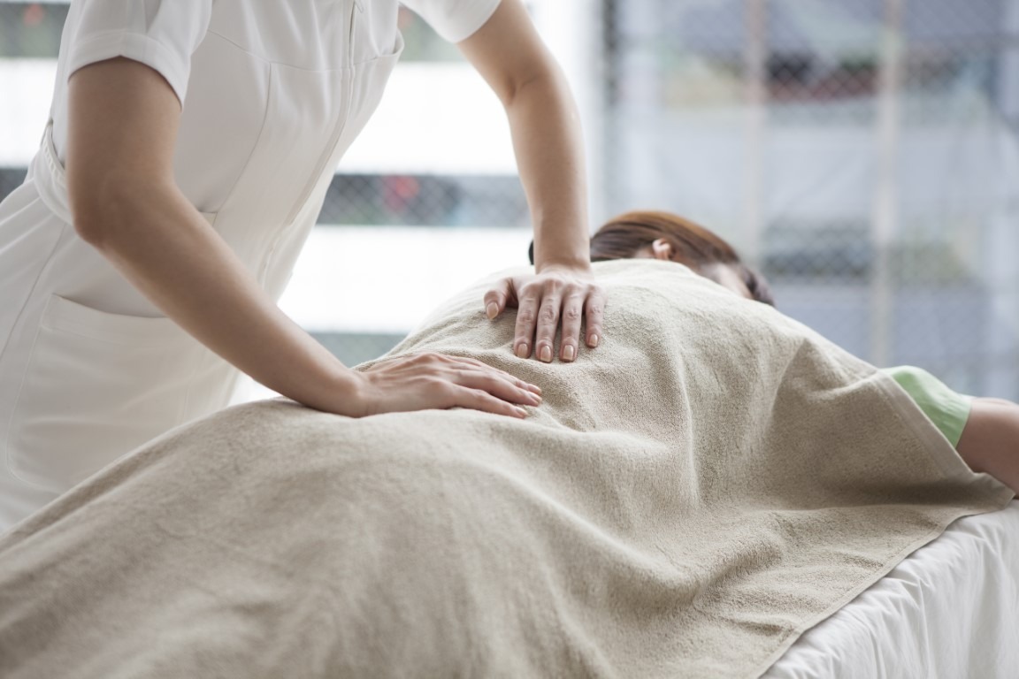 Acupuncturist beginning treatment on a patient.